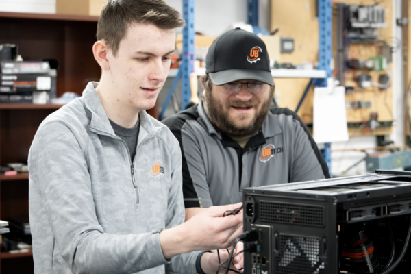 An IT student collaborates with peers to build a custom computer as part of a hands on project during the UBTech Student Showcase.