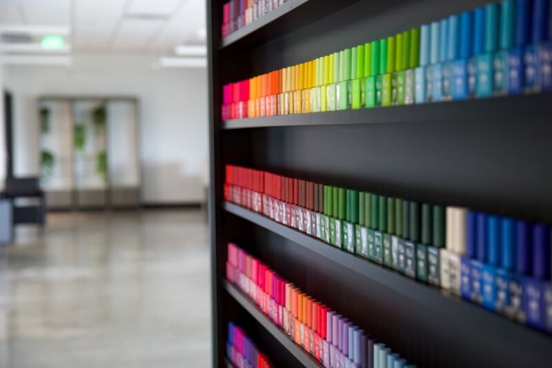 Colorful rainbow rows of nail polish leading the way into the salon.
