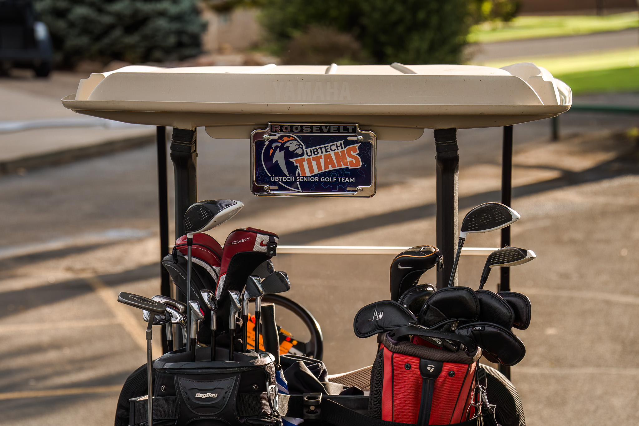 Golf cart with two sets of clubs with UBTech Titans license plate