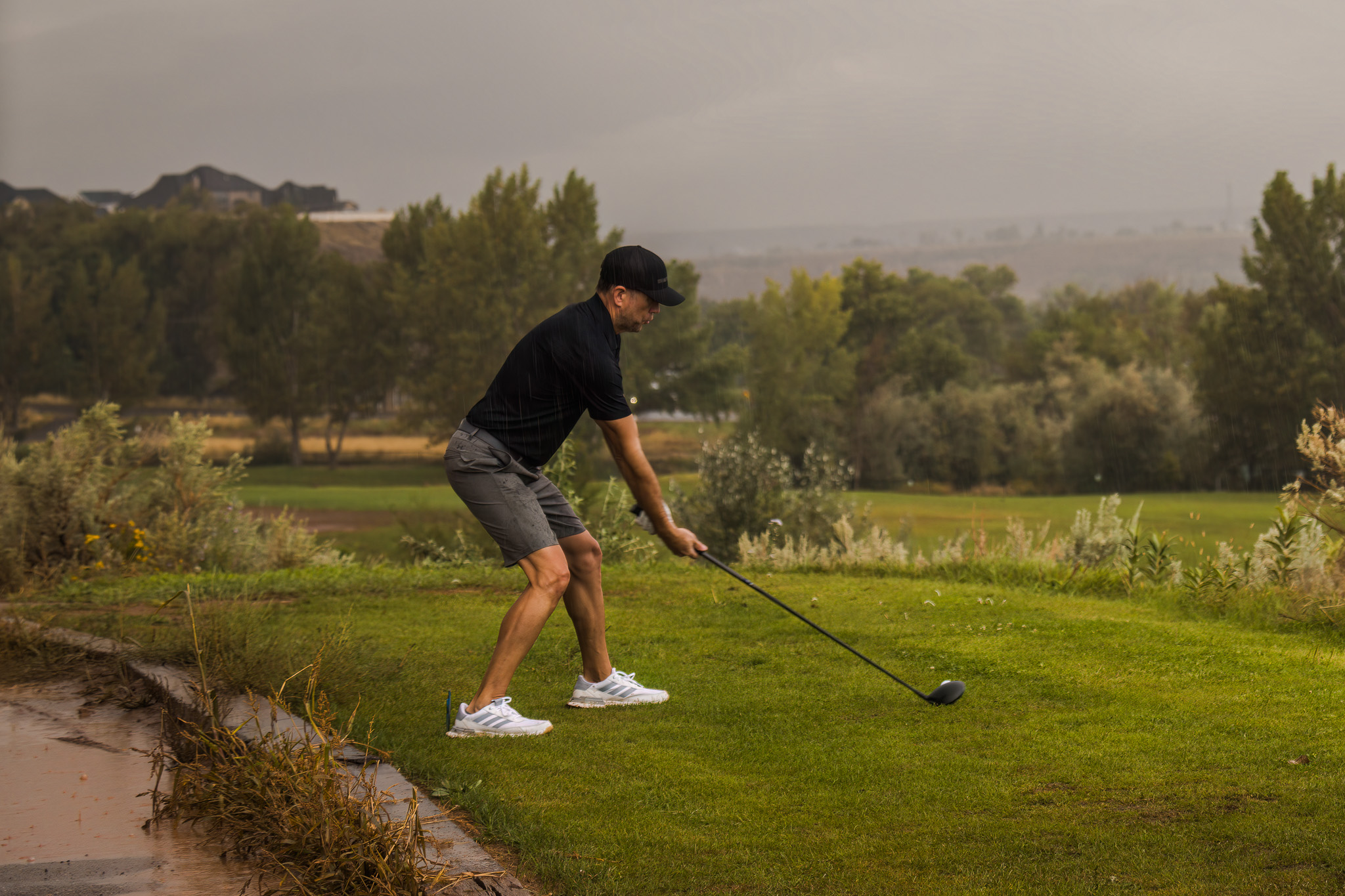 a man getting ready to hit a golf ball