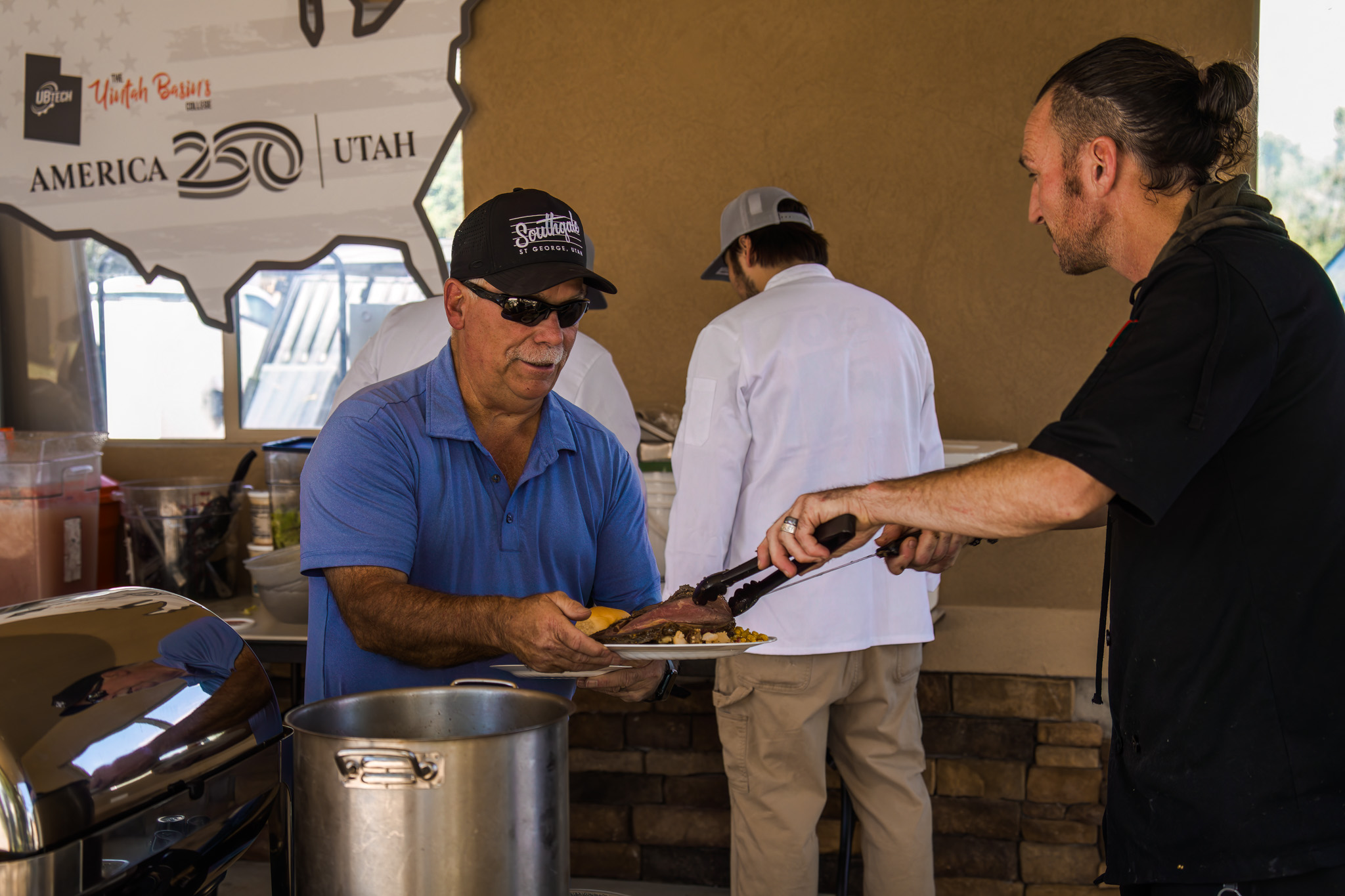 the male chief serving a man lunch